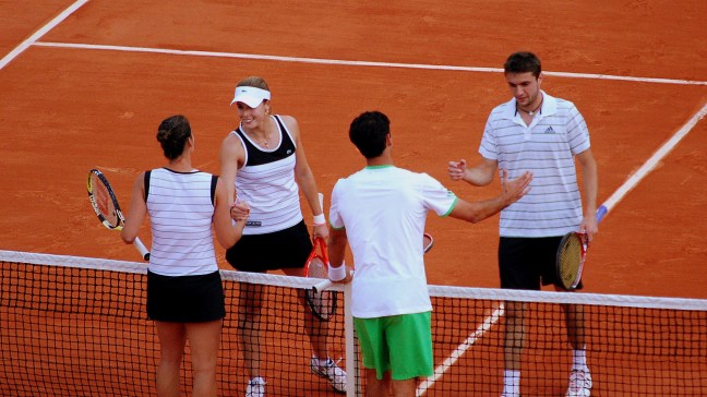mixed doubles players shaking hands at net
